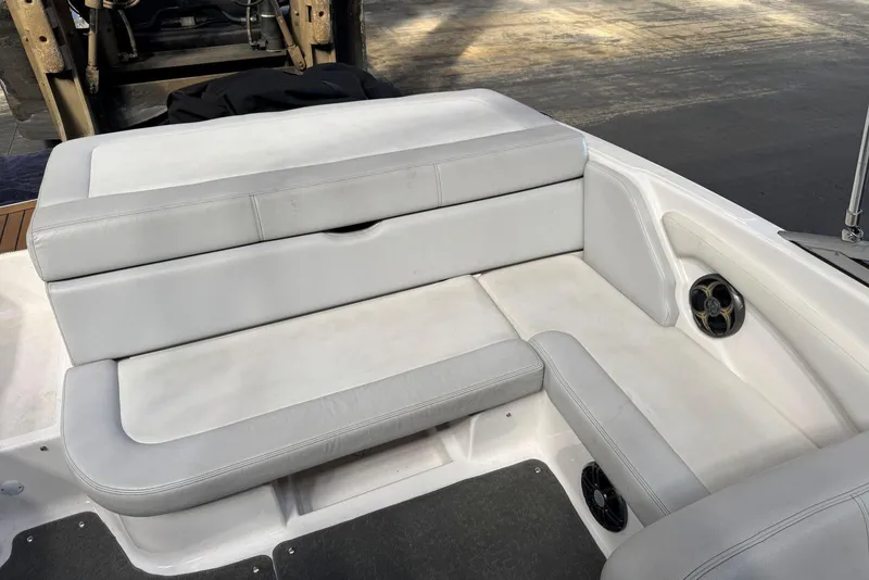 Slide: The Image of 2014 Regal 1900 ES Bowrider interior seating with white upholstery and speaker. - 11