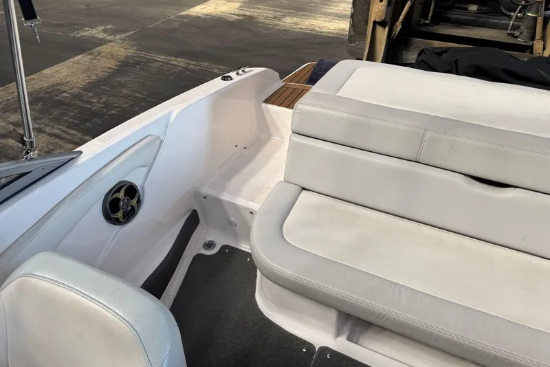 Slide: The Image of 2014 Regal 1900 ES Bowrider interior with white seating and speaker detail. - 12