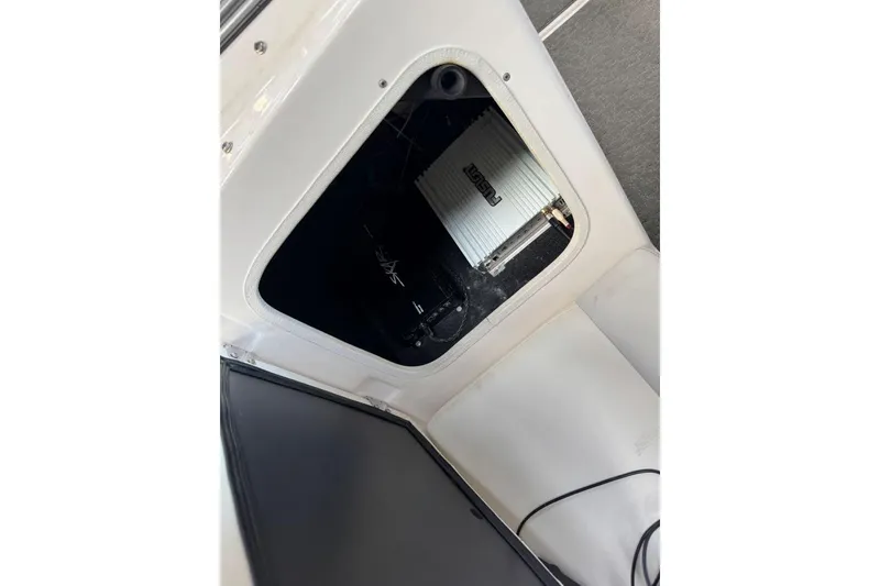 Slide: The Image of 2014 Regal 1900 ES Bowrider storage compartment with audio equipment. - 21