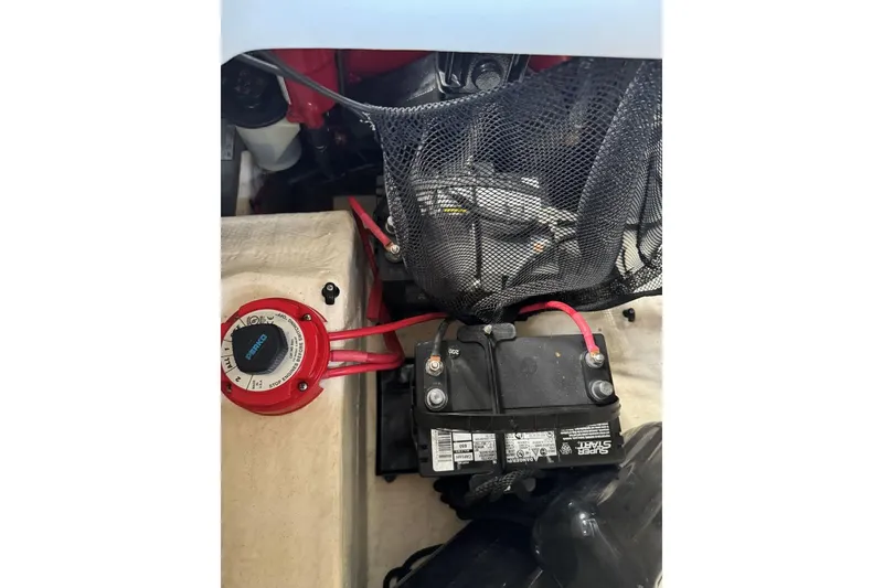 Slide: The Image of Battery compartment of 2014 Regal 1900 ES Bowrider with wiring and switch. - 27