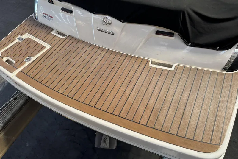 Slide: The Image of 2014 Regal 1900 ES Bowrider swim platform with wood finish and sleek design. - 6