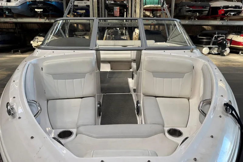 Slide: The Image of 2014 Regal 1900 ES Bowrider with white interior, docked in a storage facility. - 7