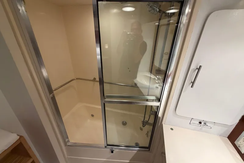 Slide: The Image of Bathroom with glass shower in 1991 Hatteras 70 Motor Yacht. - 107