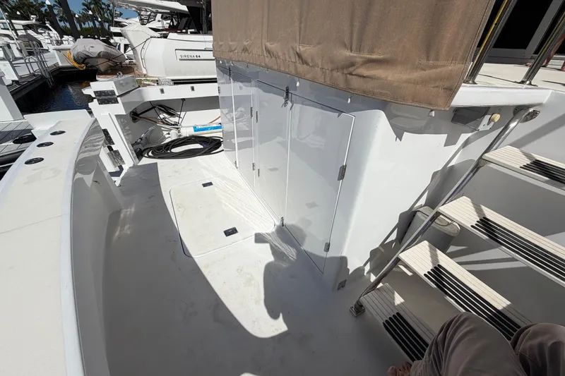 Slide: The Image of 1991 Hatteras 70 Motor Yacht deck with stairs and storage compartments. - 23