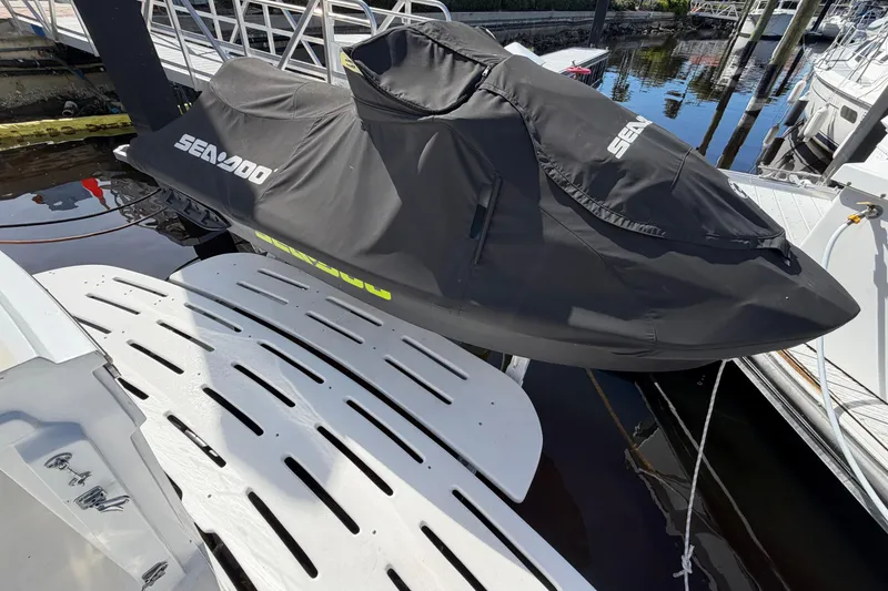 Slide: The Image of Covered Sea-Doo jet ski on dock near 1991 Hatteras 70 Motor Yacht. - 38