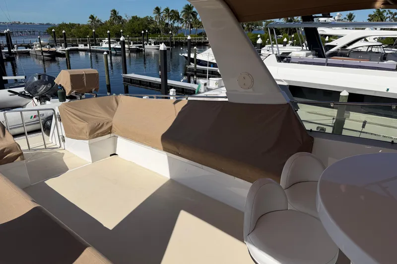 Slide: The Image of 1991 Hatteras 70 Motor Yacht deck with seating, docked at marina. - 41