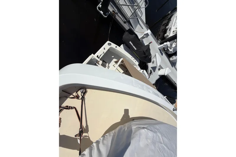 Slide: The Image of 1991 Hatteras 70 Motor Yacht docked, view from above, showing deck and nearby watercraft. - 53