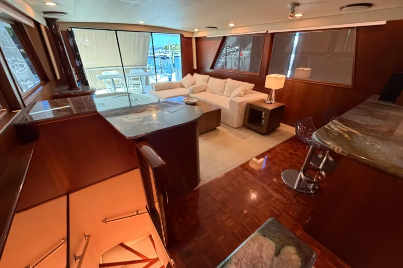 Slide: The Image of Luxurious interior of 1991 Hatteras 70 Motor Yacht with elegant wood finishes and modern furnishings. - 54