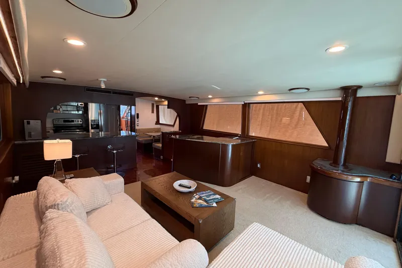 Slide: The Image of Luxurious interior of 1991 Hatteras 70 Motor Yacht with modern kitchen and cozy seating area. - 56