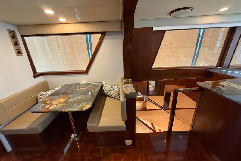Slide: The Image of Interior of 1991 Hatteras 70 Motor Yacht with elegant dining area and wood accents. - 59