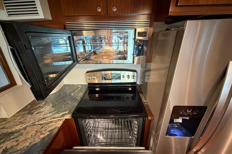 Slide: The Image of Kitchen area of a 1991 Hatteras 70 Motor Yacht with modern appliances. - 66