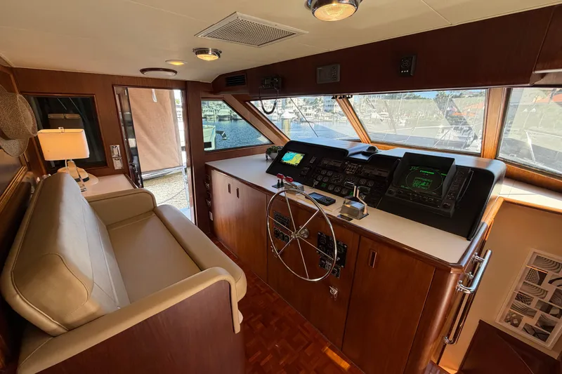 Slide: The Image of Interior helm of 1991 Hatteras 70 Motor Yacht with steering wheel and navigation equipment. - 68