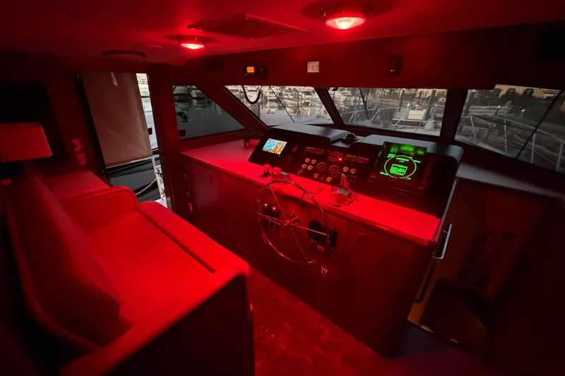 Slide: The Image of Red-lit helm of 1991 Hatteras 70 Motor Yacht with navigation instruments. - 71