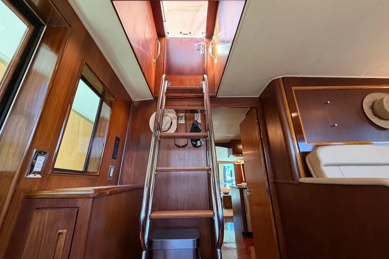Slide: The Image of Interior of 1991 Hatteras 70 Motor Yacht with wooden stairs and elegant design. - 73