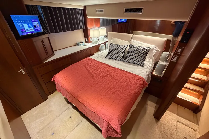 Slide: The Image of Bedroom interior of 1991 Hatteras 70 Motor Yacht with cozy bed and modern amenities. - 77