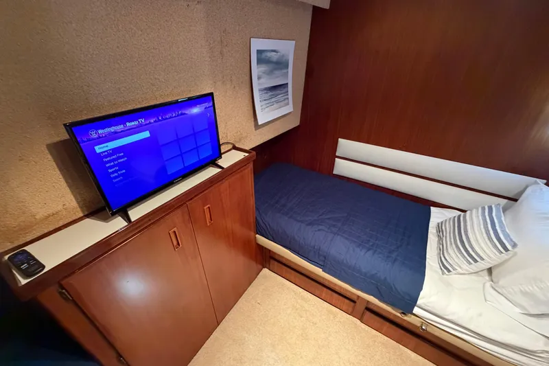 Slide: The Image of Cozy cabin interior of 1991 Hatteras 70 Motor Yacht with TV and single bed. - 83