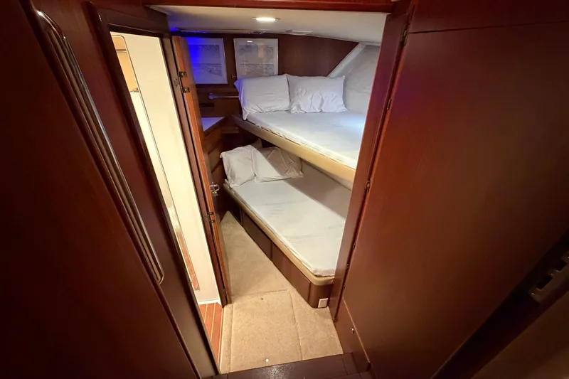 Slide: The Image of Interior cabin of 1991 Hatteras 70 Motor Yacht with bunk beds and wooden finish. - 90