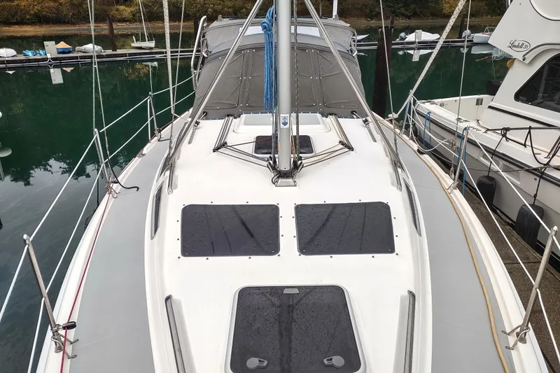 Slide: The Image of 2003 Hunter 356 sailboat docked, showcasing deck and rigging details. - 12