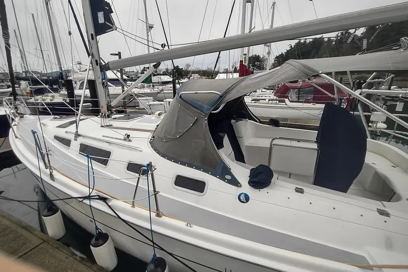 Slide: The Image of 2003 Hunter 356 sailboat docked at marina, featuring sleek design and spacious cockpit. - 14