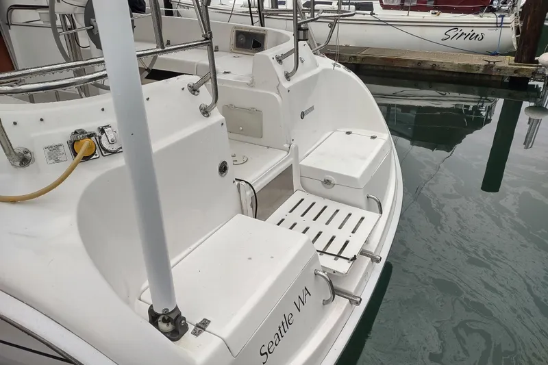 Slide: The Image of 2003 Hunter 356 sailboat docked in Seattle, WA, with visible deck and seating area. - 19