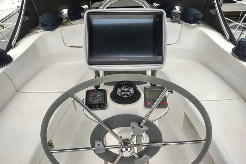 Slide: The Image of Steering wheel and navigation system of 2003 Hunter 356 sailboat cockpit. - 20