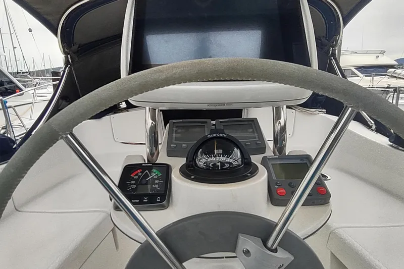 Slide: The Image of Steering console of a 2003 Hunter 356 sailboat with navigation instruments and compass. - 21