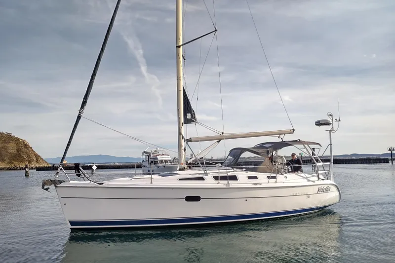 Slide: The Image of 2003 Hunter 356 sailboat docked in calm waters under a clear sky. - 3