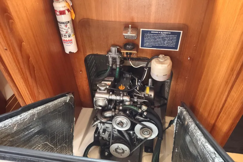 Slide: The Image of Engine compartment of a 2003 Hunter 356 sailboat, featuring a compact marine engine. - 44