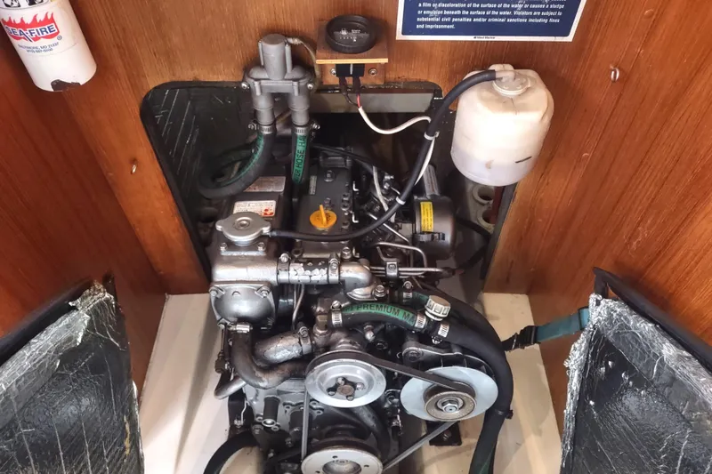 Slide: The Image of Engine compartment of a 2003 Hunter 356 sailboat, featuring mechanical components and hoses. - 45