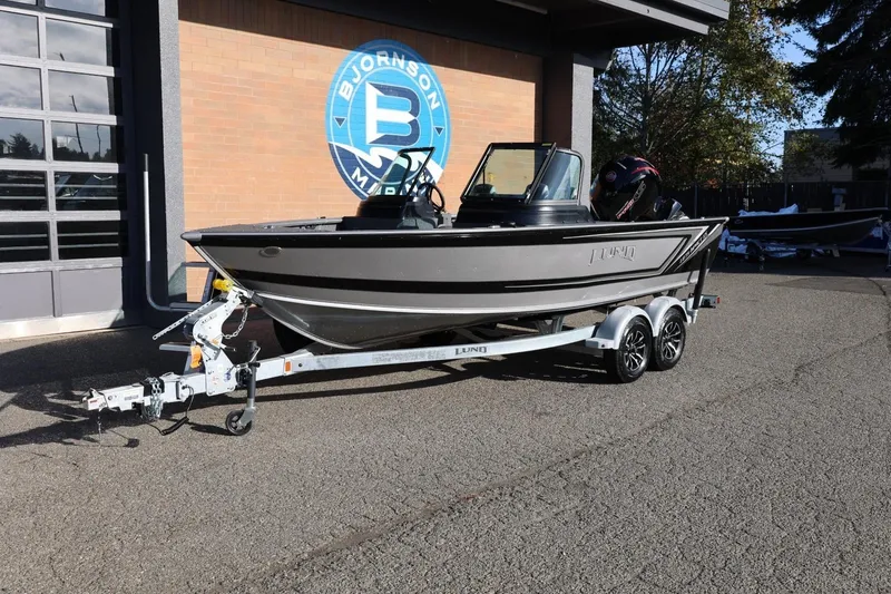 Slide: The Image of 2026 Lund 1875 Impact XS Sport boat on trailer outside Bjornson Marine. - 11