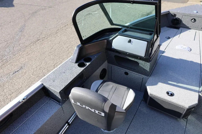 Slide: The Image of 2026 Lund 1875 Impact XS Sport boat interior with seating and storage compartments. - 15