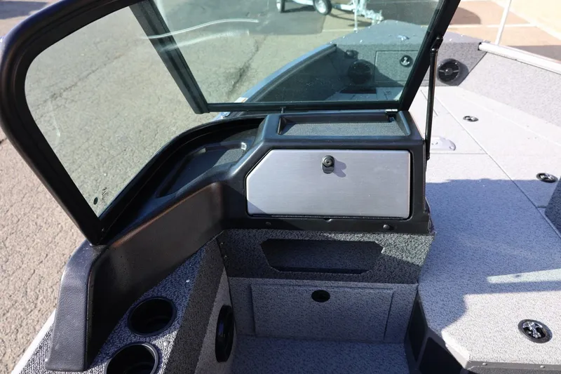 Slide: The Image of 2026 Lund 1875 Impact XS Sport boat interior with windshield and storage compartment. - 22