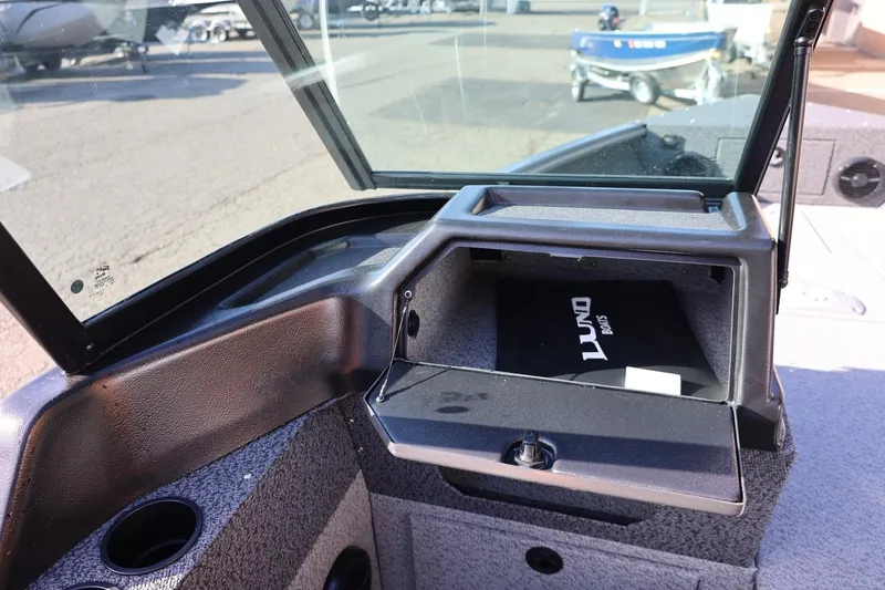 Slide: The Image of 2026 Lund 1875 Impact XS Sport boat interior with open storage compartment. - 23