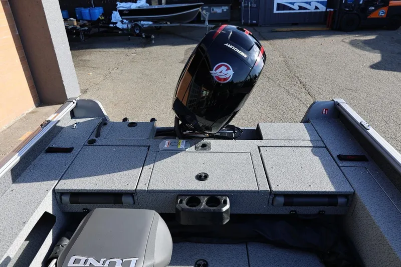 Slide: The Image of 2026 Lund 1875 Impact XS Sport boat with Mercury outboard motor, rear deck view. - 28
