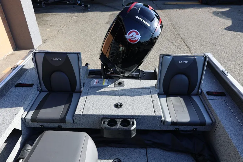 Slide: The Image of 2026 Lund 1875 Impact XS Sport boat interior with Mercury engine, featuring comfortable seating. - 29