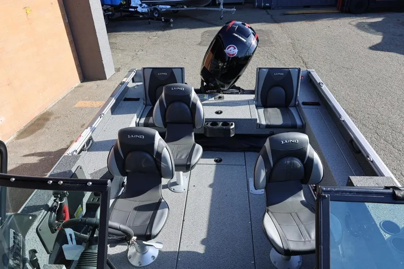 Slide: The Image of 2026 Lund 1875 Impact XS Sport boat interior with seating and motor. - 30