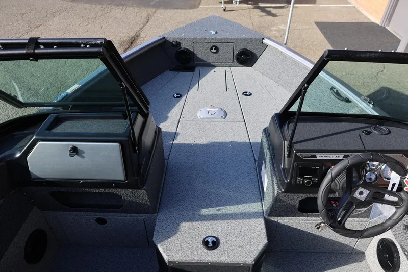 Slide: The Image of 2026 Lund 1875 Impact XS Sport boat interior with open windshield and steering console. - 34
