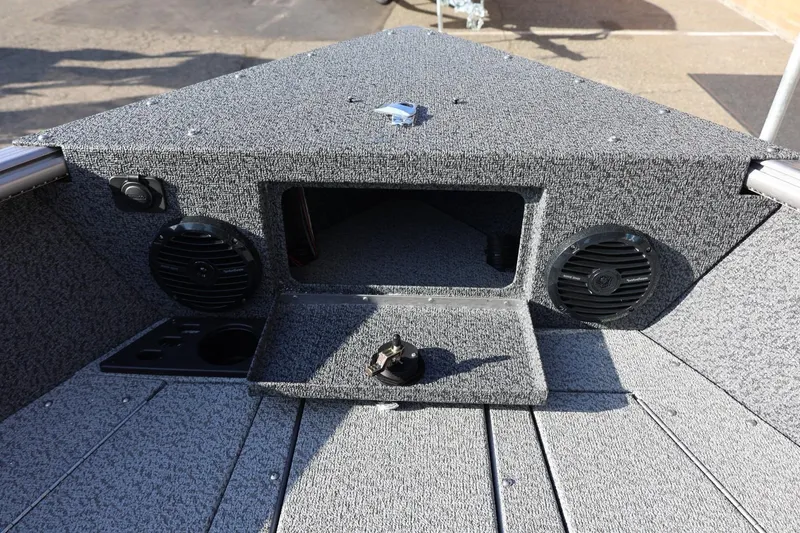 Slide: The Image of 2026 Lund 1875 Impact XS Sport boat interior with speakers and storage compartment. - 37