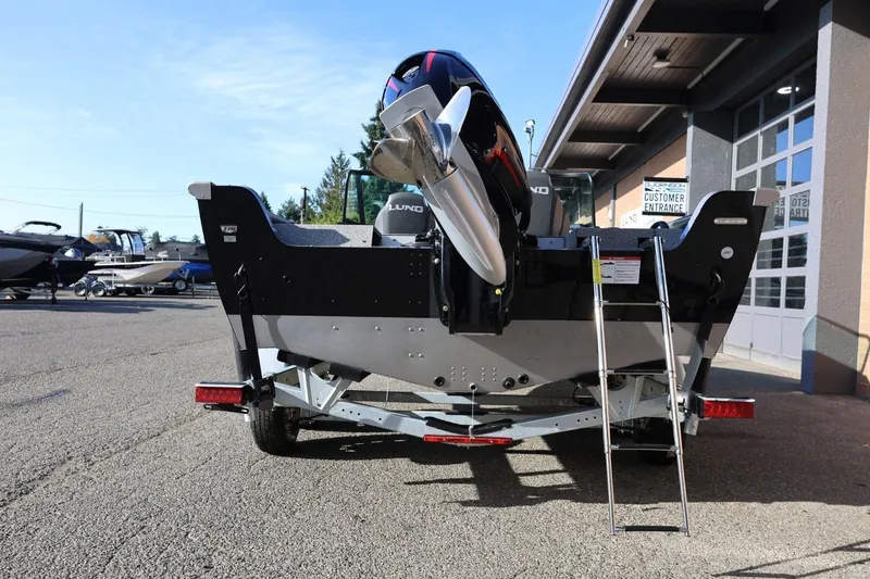 Slide: The Image of 2026 Lund 1875 Impact XS Sport boat rear view with ladder and motor. - 4