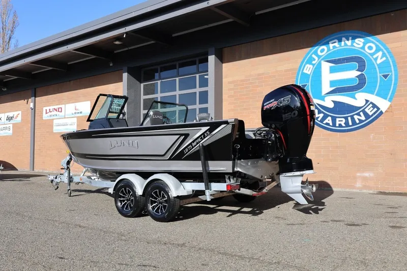 Slide: The Image of 2026 Lund 1875 Impact XS Sport boat on trailer at Bjornson Marine dealership. - 43