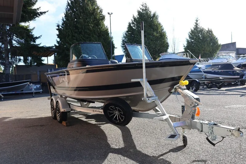 Slide: The Image of 2026 Lund 1875 Impact XS Sport boat on trailer in outdoor setting. - 8