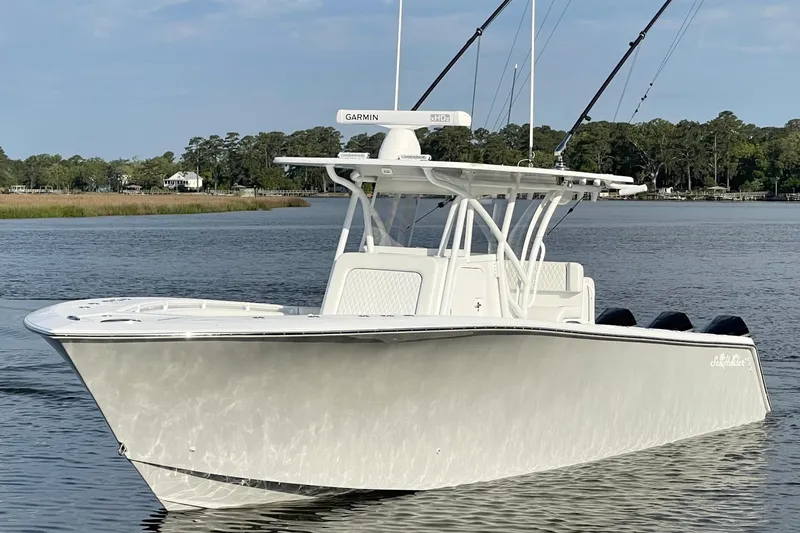 Slide: The Image of 2022 SeaHunter 33 Tournament boat on calm water, featuring fishing rods and Garmin equipment. - 1