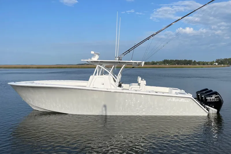 Slide: The Image of 2022 SeaHunter 33 Tournament boat on calm water, featuring twin outboard engines. - 3