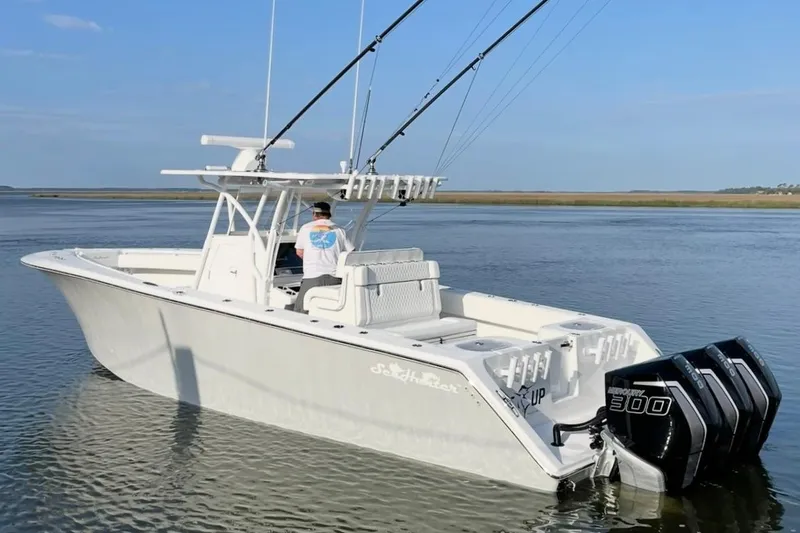 Slide: The Image of 2022 SeaHunter 33 Tournament boat with triple Mercury 300 engines on calm water. - 5