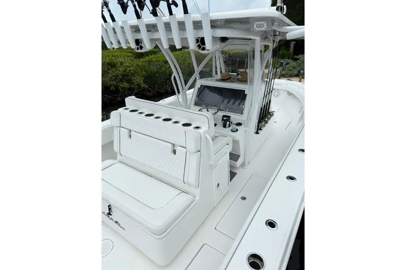 Slide: The Image of 2022 SeaHunter 33 Tournament boat interior with seating and fishing rod holders. - 7
