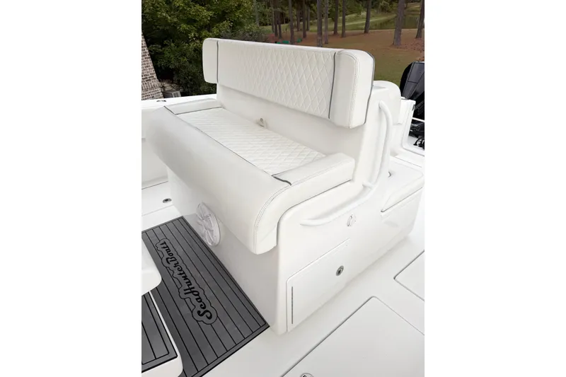 Slide: The Image of 2022 SeaHunter 33 Tournament boat with white cushioned seating and deck mat. - 8