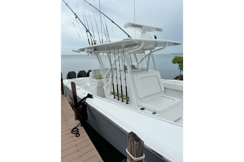 Slide: The Image of 2022 SeaHunter 33 Tournament boat docked, equipped with fishing rods and Garmin electronics. - 9