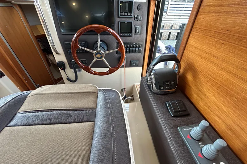 Slide: The Image of 2017 Ranger Tugs R-31 CB helm with wooden steering wheel and control panel. - 17