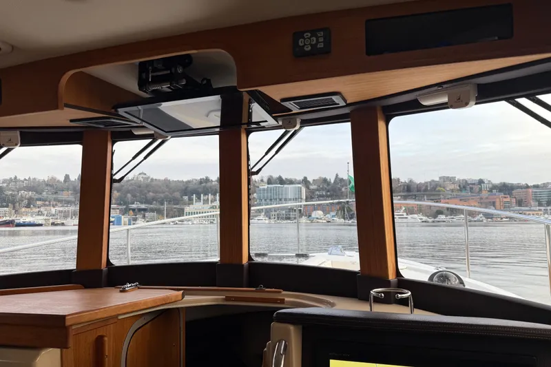 Slide: The Image of Interior view from 2017 Ranger Tugs R-31 CB, overlooking a scenic waterfront. - 19