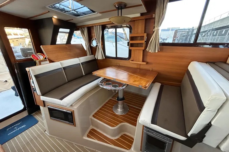 Slide: The Image of Interior of 2017 Ranger Tugs R-31 CB with wood accents and seating area. - 23